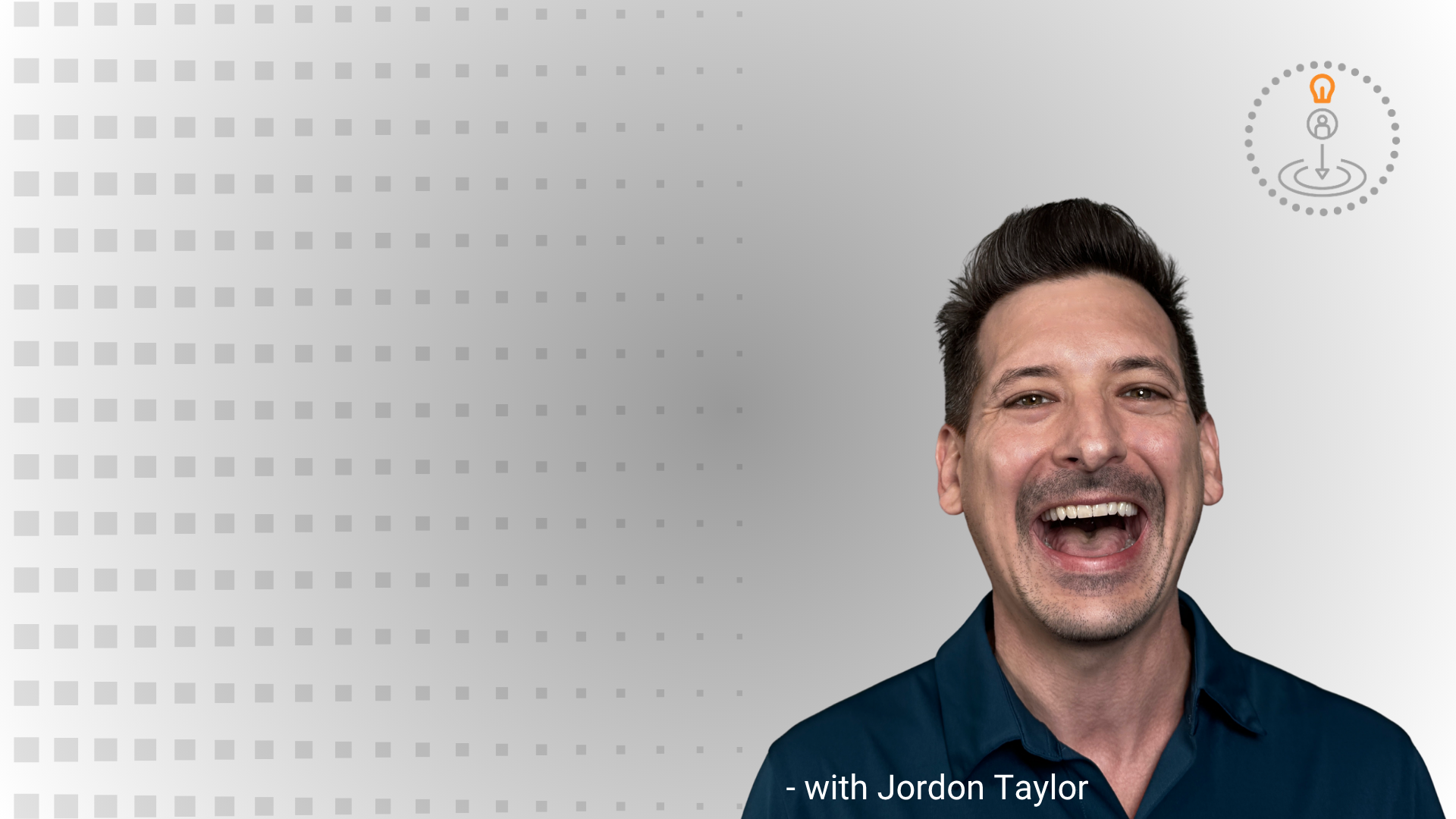 A picture of Jordon Taylor in a blue shirt smiling with a grey background.